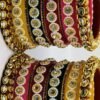 Multicolored Rajasthani Chuda split into two sets for each hand, showcasing intricate kundan stone work and vibrant hues.