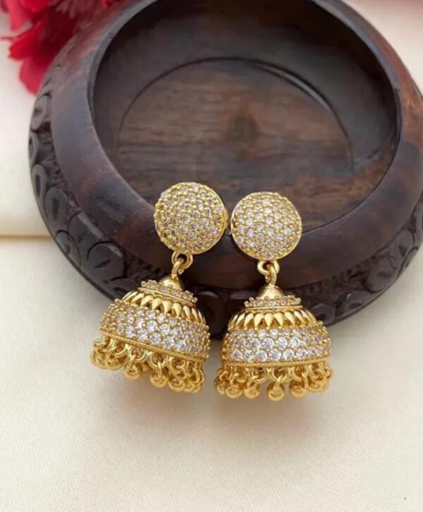 Side-angle view of gold-plated American diamond jhumki earrings, showcasing intricate detailing and sparkling stones—perfect for ethnic and modern wear.