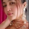 Model wearing gold-plated multi-layered Kundan jhumki earrings, highlighting their long ethnic drop style and regal appeal.