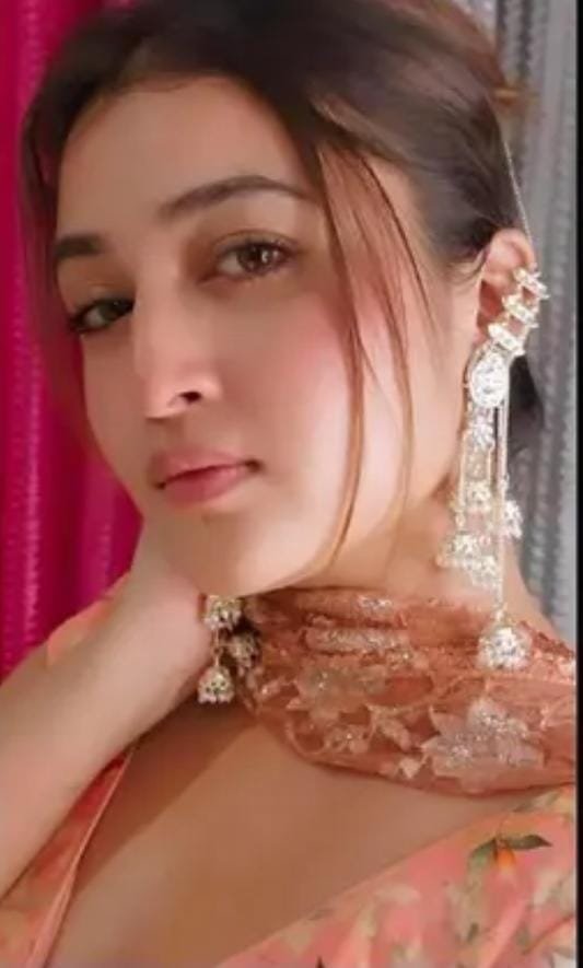 Model wearing gold-plated multi-layered Kundan jhumki earrings, highlighting their long ethnic drop style and regal appeal.