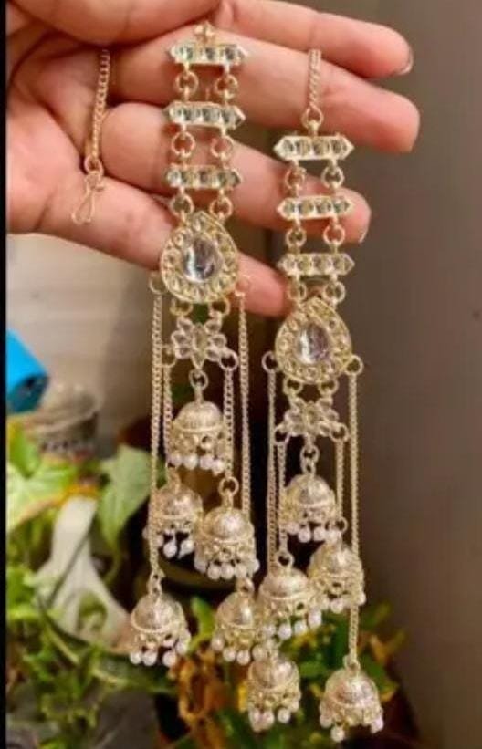 Gold-plated multi-layered jhumki earrings with Kundan stones, featuring an elegant long ethnic design. Ideal for weddings, festive occasions, and traditional wear.