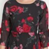 Close-up of black floral maxi dress featuring pink roses, round neck, bell sleeves, and detailed georgette fabric texture.