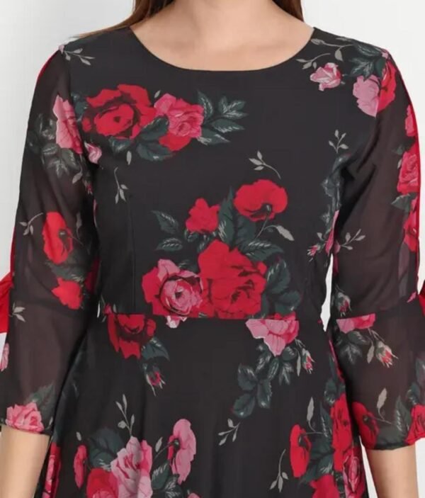 Close-up of black floral maxi dress featuring pink roses, round neck, bell sleeves, and detailed georgette fabric texture.