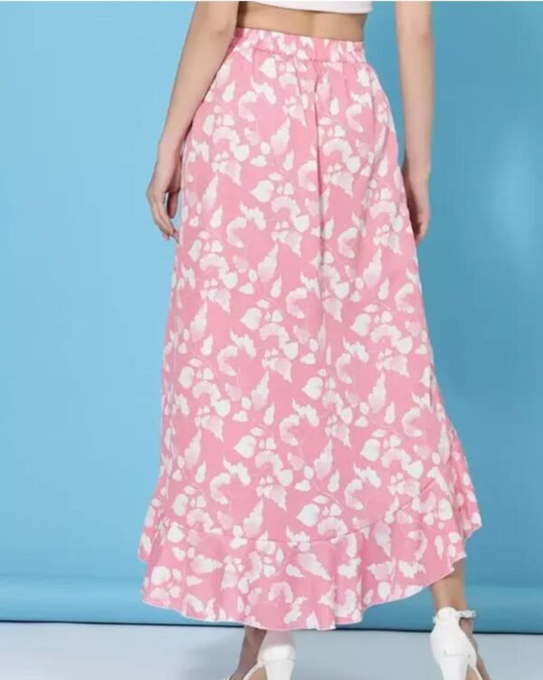 Back view of a women's floral asymmetric high-low skirt in pink, highlighting the cascading hemline and crepe fabric.