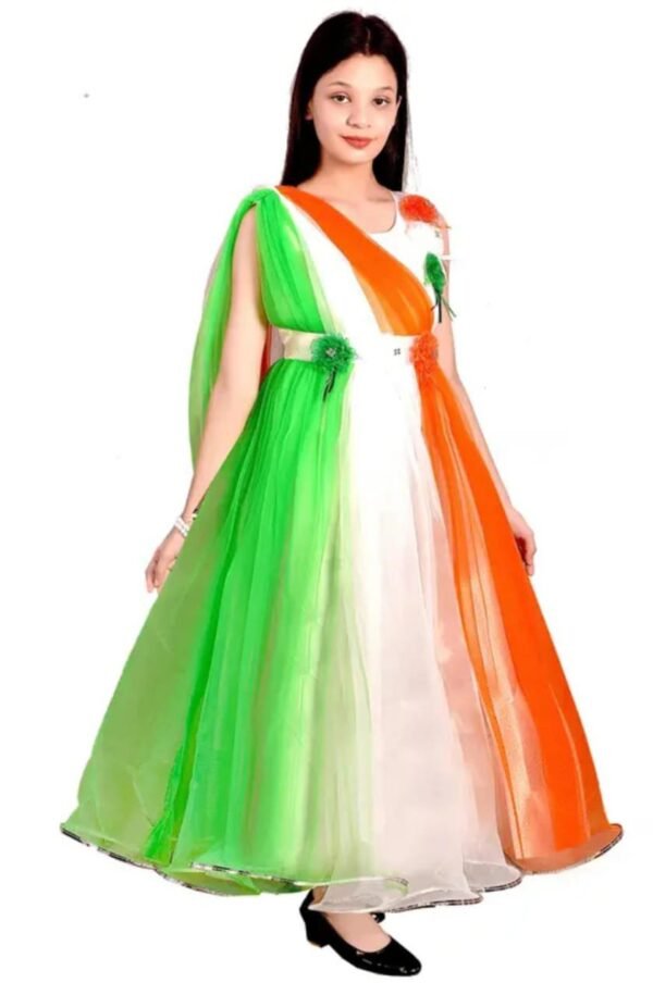 Child wearing a dress with vertical green, white, and orange panels representing the Indian flag, decorated with green and orange flower embellishments at the waist and shoulder